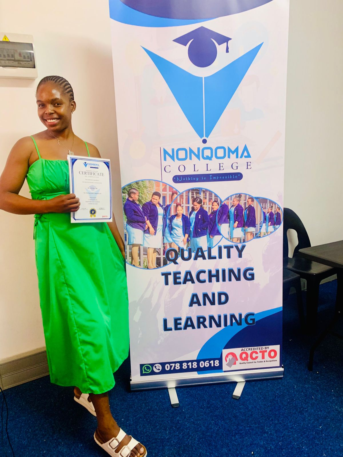 Nonqoma College graduate holding her certificate of completion